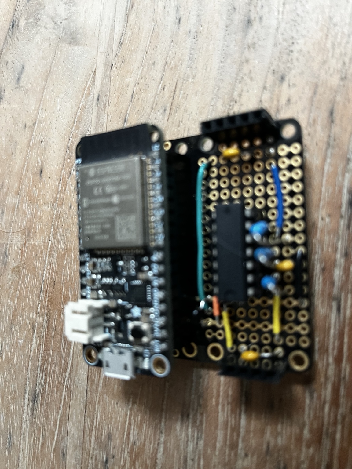 Photograph of a BacMan prototype with Feather microcontroller and hand-assembled sensor electronics